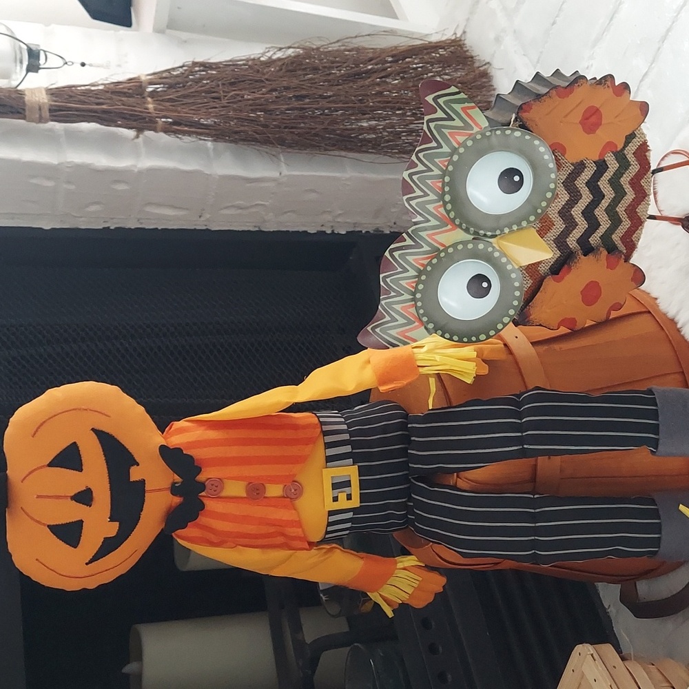 Posable scarecrow with basket its sitting on and metal owl selling together.